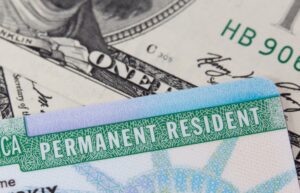 Green Card on top of dollar bills