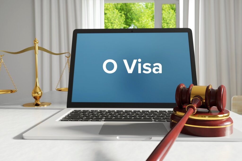O Visa written on a laptop screen next to a gavel and scale