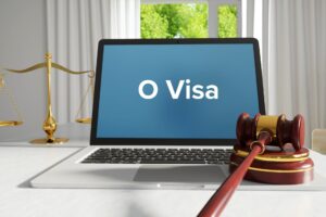 O Visa written on a laptop screen next to a gavel and scale