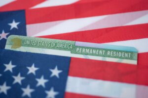 American flag with a permanent resident card on top