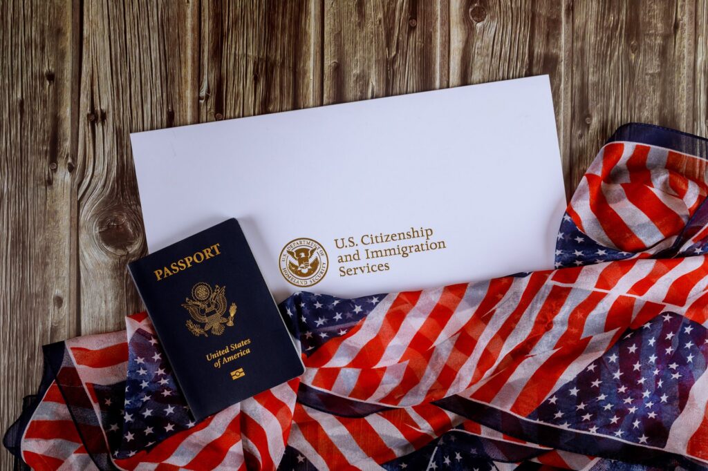 American flag, passport and envelop that says U.S. Citizenship