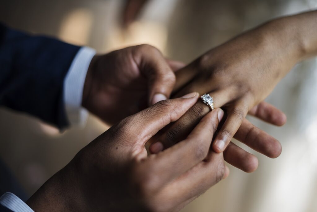 Groom Puts Wedding Ring on Bride Hand | Green Card Marriage Interview | U.S. Immigration Law Counsel