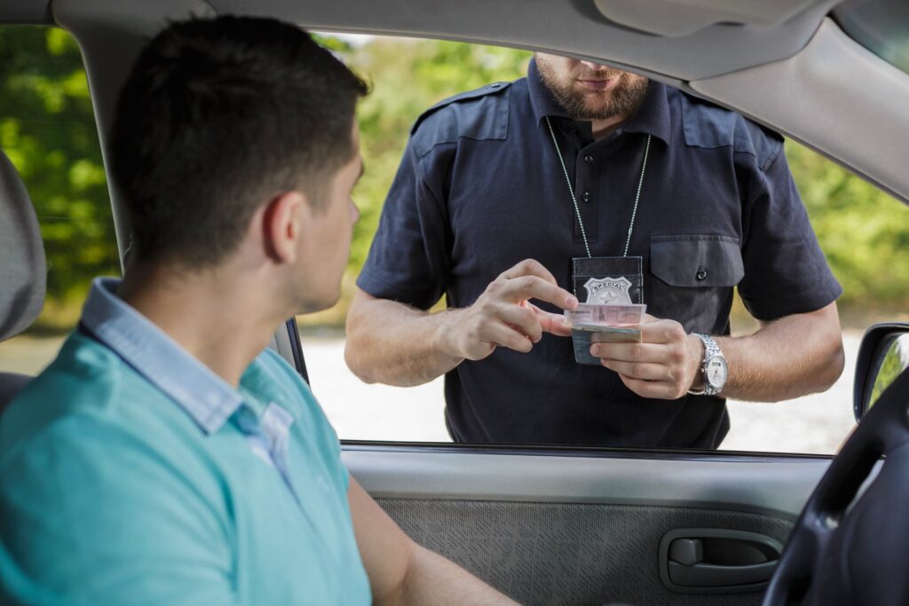 Police officer looking at ID card