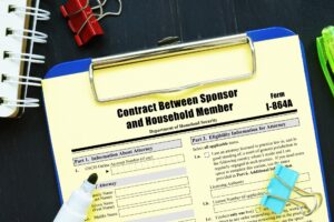 Clipboard with Form I-864A on it
