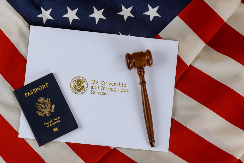 Gavel, passport, and envelope on top of American flag