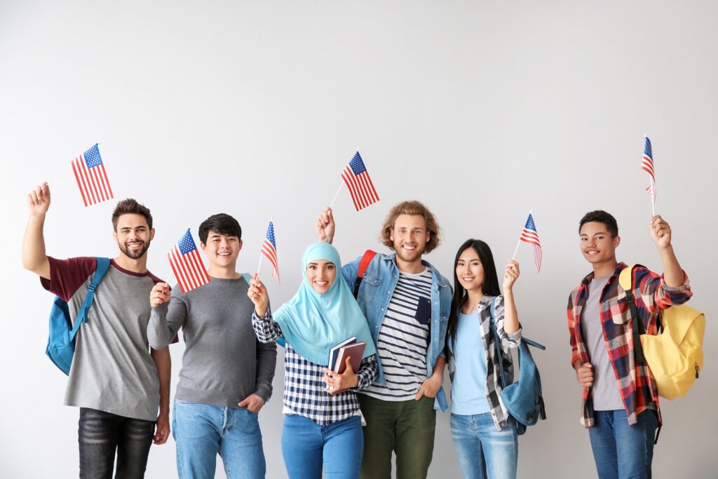 Group of Students with USA Flags | Trusted Visa & Immigration Lawyer | U.S. Immigration Law Counsel