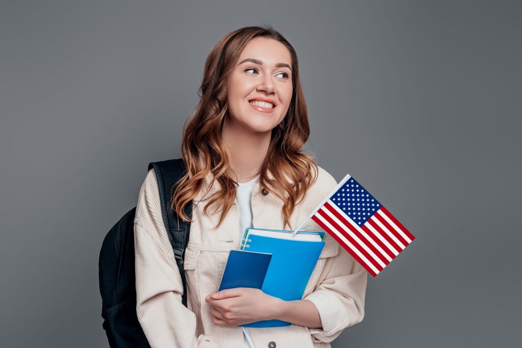 Girl Holding Book, Passport & US Flag | Skilled Student Visa Lawyers | U.S. Immigration Law Counsel
