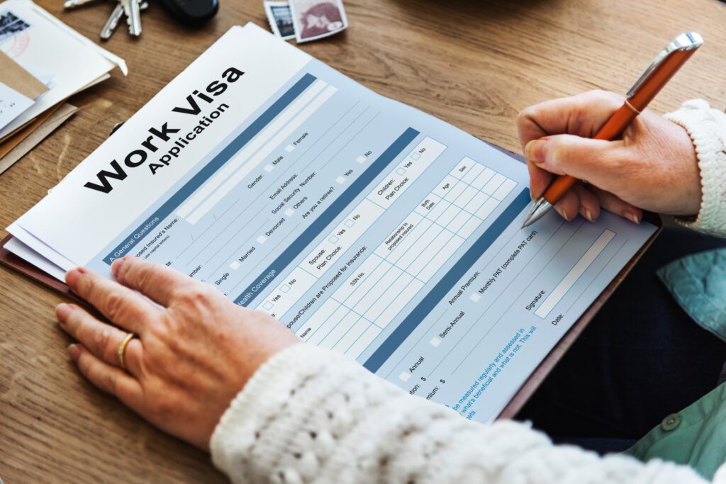 Someone filling out a work visa application