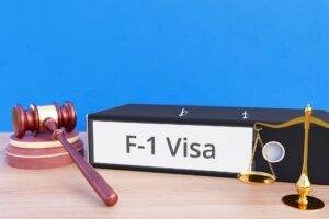 F-1 Visa Binder next to a gavel and scale