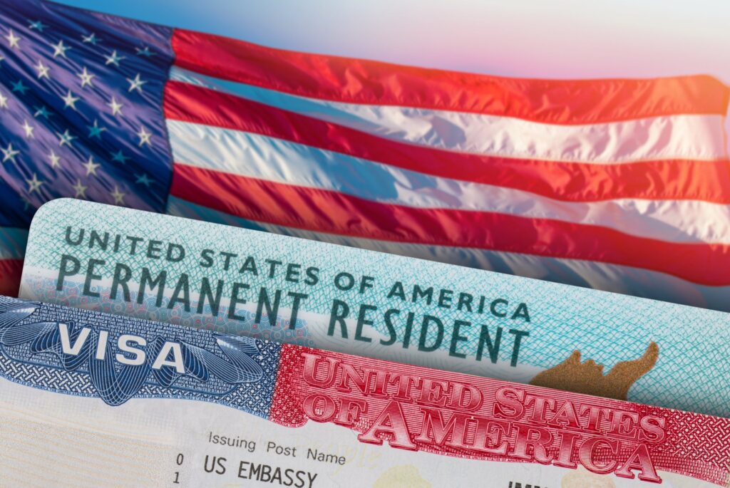 An american flag, visa and permanent resident card