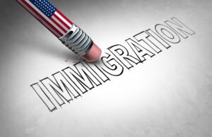 American flag pencil erasing the word immigration on a white background