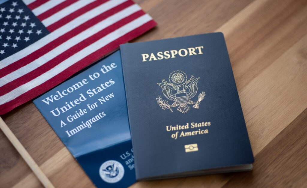 US Passport Next to a Guide for New Immigrants | Citizenship Lawyers | U.S. Immigration Law Counsel