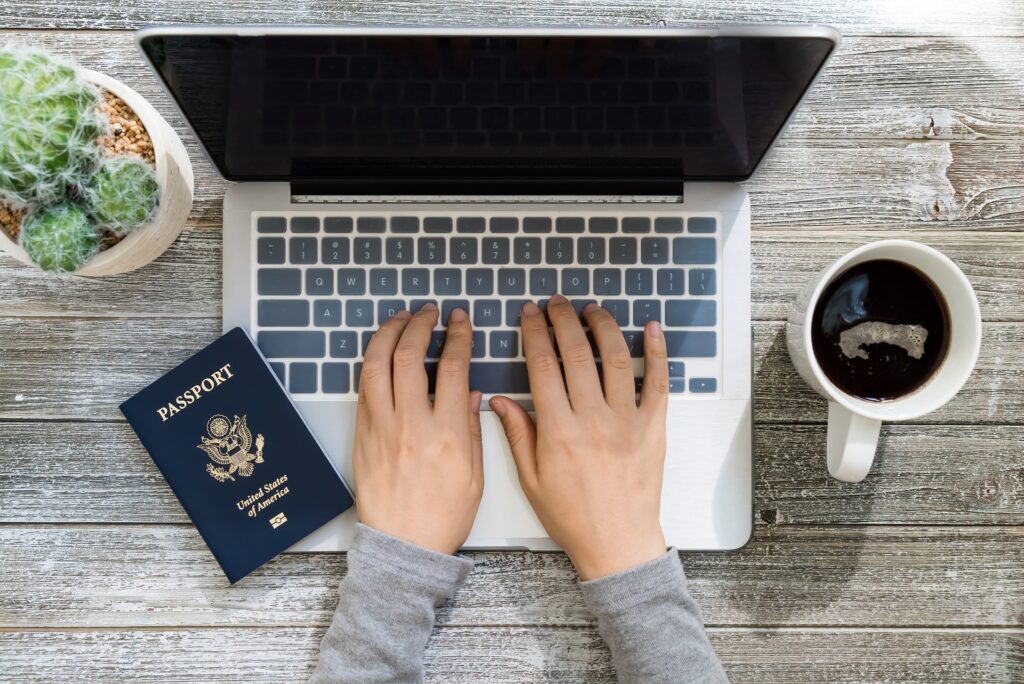 Man Using Laptop with American Passport | Expert Immigration Case | U.S. Immigration Law Counsel