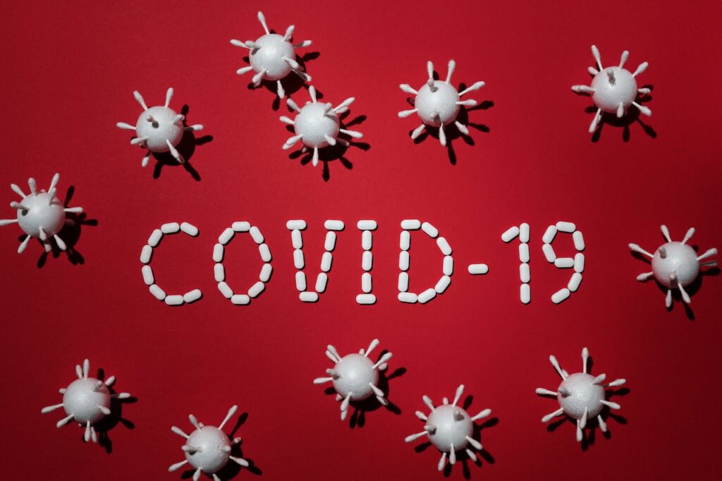 Red Background With White Covid-19 Virus | H1B Visa Attorneys | U.S. Immigration Law Counsel